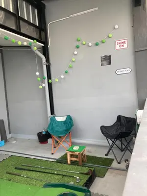 a room with two chairs and a table and green mats at Best Stay 394 homestay in Phra Khanong