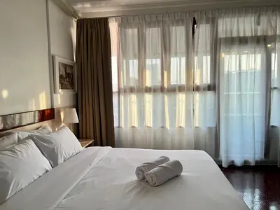 a hotel room with a bed with a towel on it at Silpasala StayZ in Sathani Ban Hua Mak