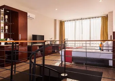 a bedroom with a bed and a desk in a room at Ratchada Point Hotel in Bangkok