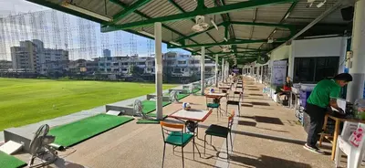 a row of tables and chairs under a roof at River View Bangkok in Bangkok
