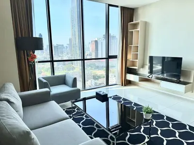 a living room with a couch and a tv at Spacious Serviced Apartment! in Bangkok