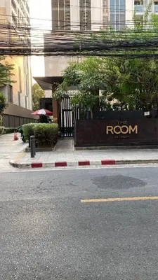a building with a sign on the side of a street at XX GO INN BTS Silom - Saint Louis สถานีรถไฟฟ้าเซนต์หลุยส์ in Bangkok