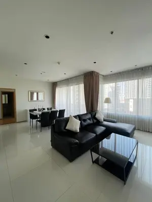 a living room with a black couch and a table at The Emporio Place in Bangkok
