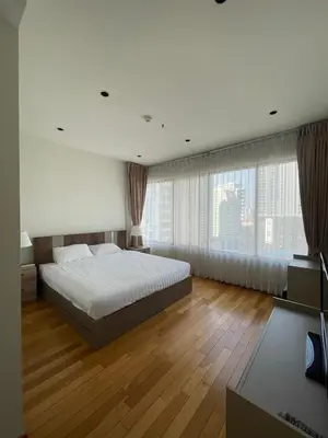 a bedroom with a bed and a large window at The Emporio Place in Bangkok