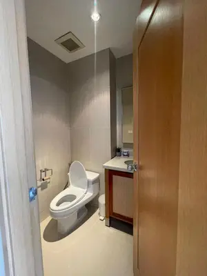 a bathroom with a toilet and a sink at The Emporio Place in Bangkok