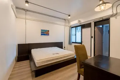a bedroom with a bed and a table in it at Silom Condominium in Bang Rak