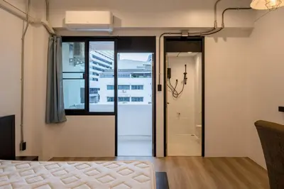 a bedroom with a glass door leading to a shower at Silom Condominium in Bang Rak