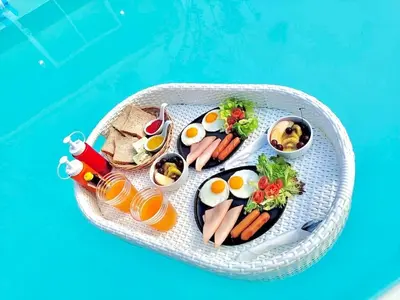 a tray of food with eggs and meat and vegetables at D Glamor Hotel Phutthamonthon Sai 1 ,Southern Bus Terminal, Bangkok in Bangkok
