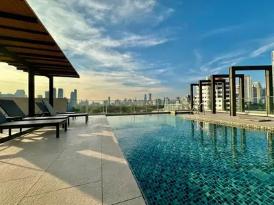 a swimming pool on the roof of a building at Cozy & Bright apartment - Asoke in Bangkok