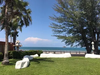 a park with white sculptures on the grass near the beach at Beach front in Hua Hin Khao Tao in Ban O Pao