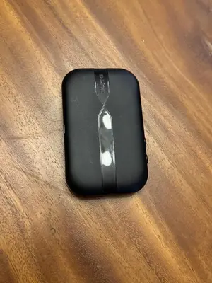 a black computer mouse sitting on a wooden table at Beach front in Hua Hin Khao Tao in Ban O Pao