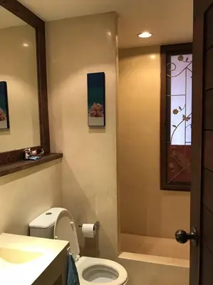 a bathroom with a toilet and a sink and a window at Beach front in Hua Hin Khao Tao in Ban O Pao