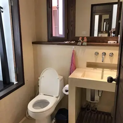 a bathroom with a toilet and a sink at Beach front in Hua Hin Khao Tao in Ban O Pao