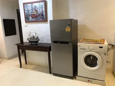 a washing machine next to a table with a washer at Beach front in Hua Hin Khao Tao in Ban O Pao