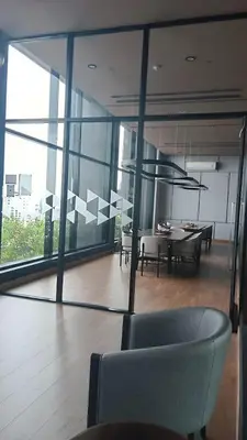 a room with a table and chairs in a building at 1 Bedroom Condo Pool Gym BTS Cowork Sky in Godown