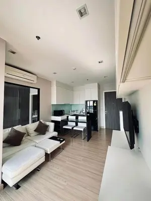 a living room with a white couch and a table at 1 Bedroom Condo Pool Gym BTS Cowork Sky in Godown