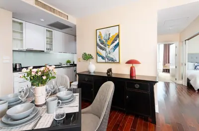 a kitchen and dining room with a table and chairs at SkyVillas Residential Apartments in Yan Nawa