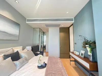 a bedroom with a large bed and a living room at Luxury Apartment Best Location Silom in Bangkok