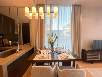 a dining room with a table and a kitchen at Luxury Apartment Best Location Silom in Bangkok