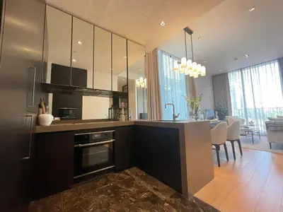 a kitchen with a counter and a dining room at Luxury Apartment Best Location Silom in Bangkok