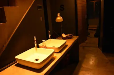 a bathroom with a sink and a mirror at Stay At pan Hostel in Bangkok