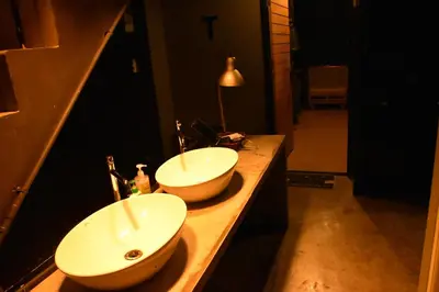 a bathroom with two sinks on a counter at Stay At pan Hostel in Bangkok