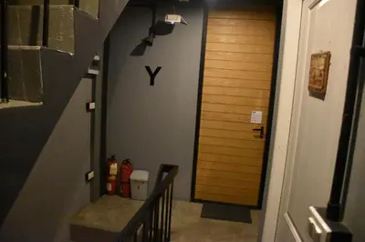 a hallway with a stairway leading into a room at Stay At pan Hostel in Bangkok