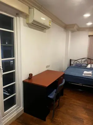a small room with a desk and a bed at Euro Classic Condominium in Bangkok