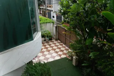 a backyard with a checkered floor and a fence at Luxury 4 KingSize BedRooms - Central & Modern Sukhumvit in Bangkok