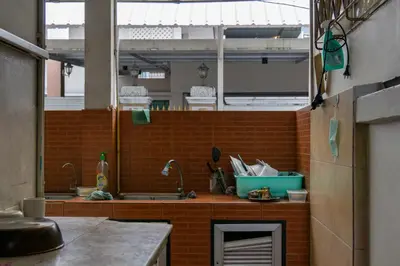 a kitchen with a sink and a brick wall at Luxury 4 KingSize BedRooms - Central & Modern Sukhumvit in Bangkok