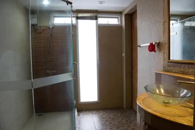 a bathroom with a sink and a glass shower at Luxury 4 KingSize BedRooms - Central & Modern Sukhumvit in Bangkok