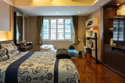 a bedroom with a bed and a television in it at Luxury 4 KingSize BedRooms - Central & Modern Sukhumvit in Bangkok