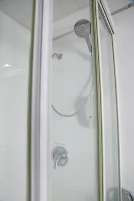 a shower with a shower head in a bathroom at UPAR Hotels Silom in Bangkok