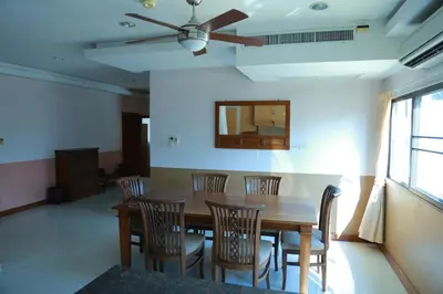 a dining room with a wooden table and chairs at UPAR Hotels Silom in Bangkok
