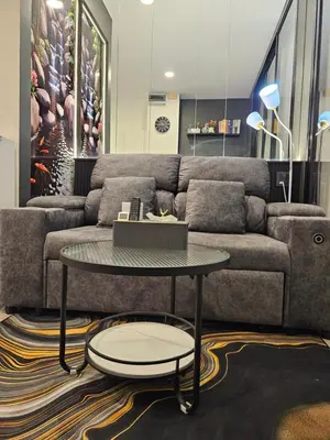 a living room with a couch and a table at Free Airport Pick Up ! 12th Floor Cozy Studio Room, 5 mins walk to IconSiam & BTS in Bangkok