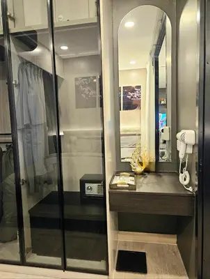 a bathroom with a shower with a sink and a mirror at Free Airport Pick Up ! 12th Floor Cozy Studio Room, 5 mins walk to IconSiam & BTS in Bangkok
