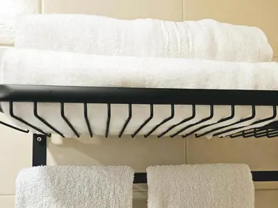a towel rack with towels on it in a bathroom at Free Airport Pick Up ! 12th Floor Cozy Studio Room, 5 mins walk to IconSiam & BTS in Bangkok