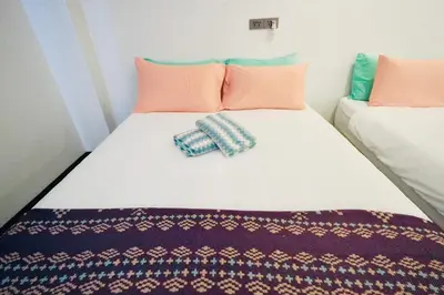 a bed with two pillows on top of it at The Local Khaosan Bangkok Hotel in Bangkok