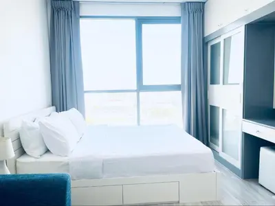 a white bed in a room with a window at Ideo Mobi Condo in Bangkok