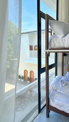 a room with a window with bunk beds in it at Shared Room Megun in Ban Bang Phlat
