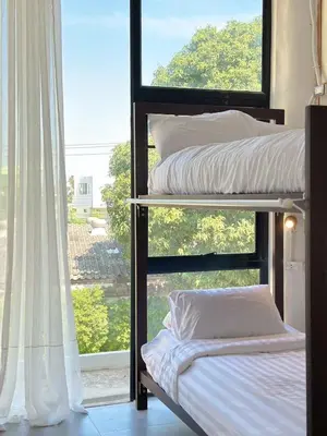 two bunk beds in a room with a window at Shared Room Megun in Ban Bang Phlat