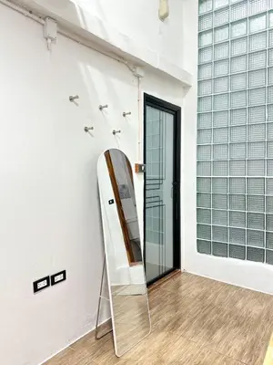 a mirror leaning against a wall in a room at Megun Room5 in Ban Bang Phlat
