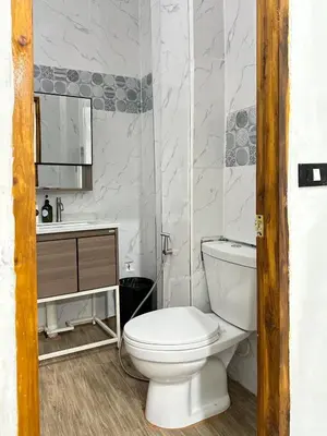 a white bathroom with a toilet and a sink at Megun Room5 in Ban Bang Phlat