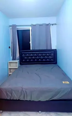 a bed in a room with a blue wall at River View Active 02 in Bangkok