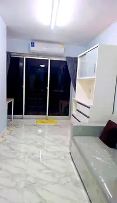 a living room with a couch and a tile floor at River View Active 02 in Bangkok