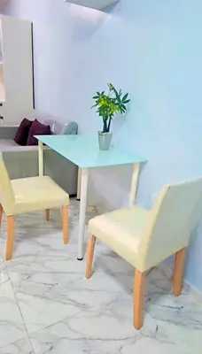 a table and two chairs with a potted plant on it at River View Active 02 in Bangkok