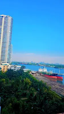 a large boat is docked in the water near a city at River View Active 3 in Bangkok