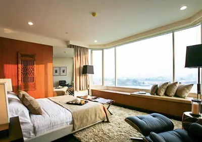 a bedroom with a large bed and a large window at Watermark Chaophraya River Condo in Bangkok