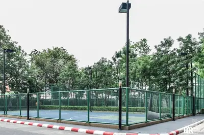 a tennis court with a fence on a tennis court at Watermark Chaophraya River Condo in Bangkok