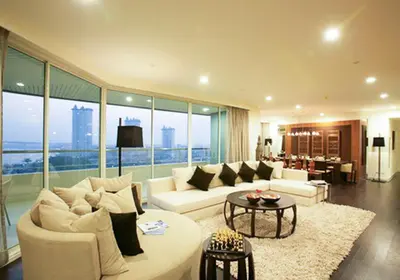 a living room with a couch and a table at Watermark Chaophraya River Condo in Bangkok